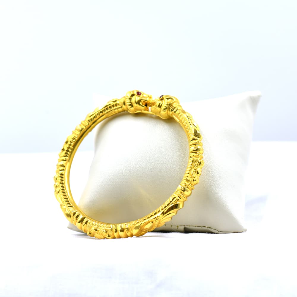 intricately designed gold hand cuff with yaali head detail